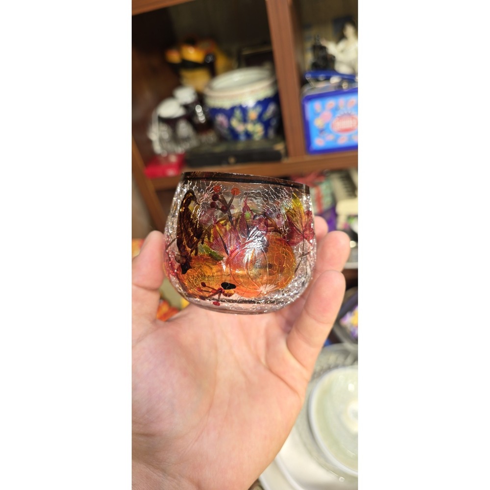 Yankee Candle crackle glass pumpkin candle holder decorated with fall foliage